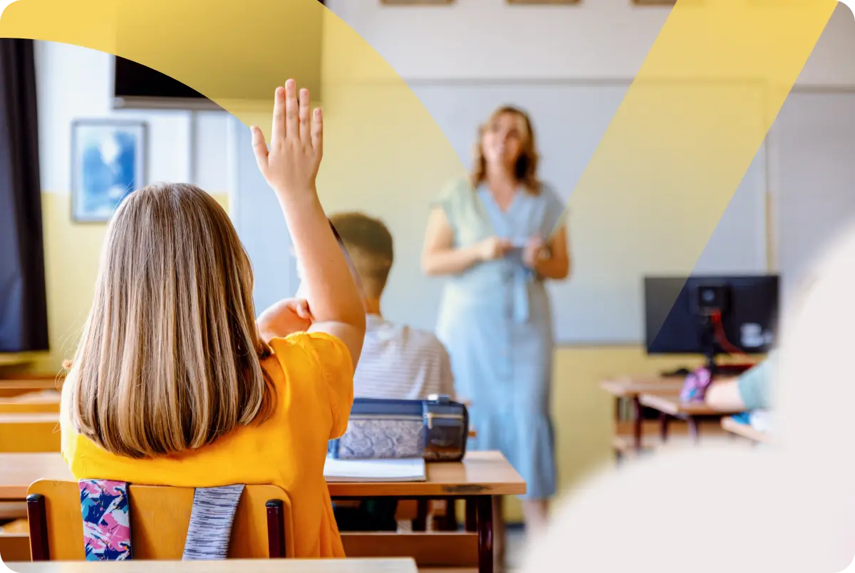Student raising a hand in a public school classroom